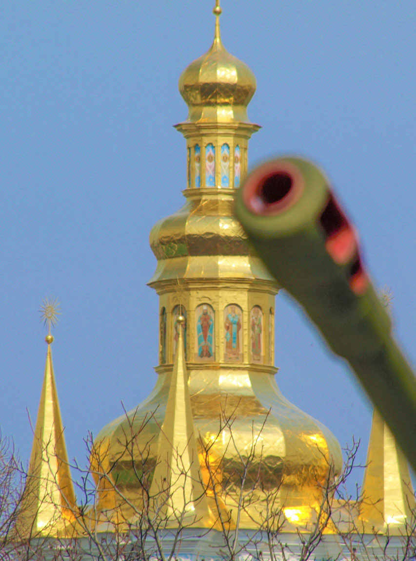 Barrel of a Soviet-era artillery gun and an Orthodox Church golden dome are symbols of the 20th Century and ongoing conflict in Ukraine.  This image was taken during Spring near the Motherland Monument in Kyiv.